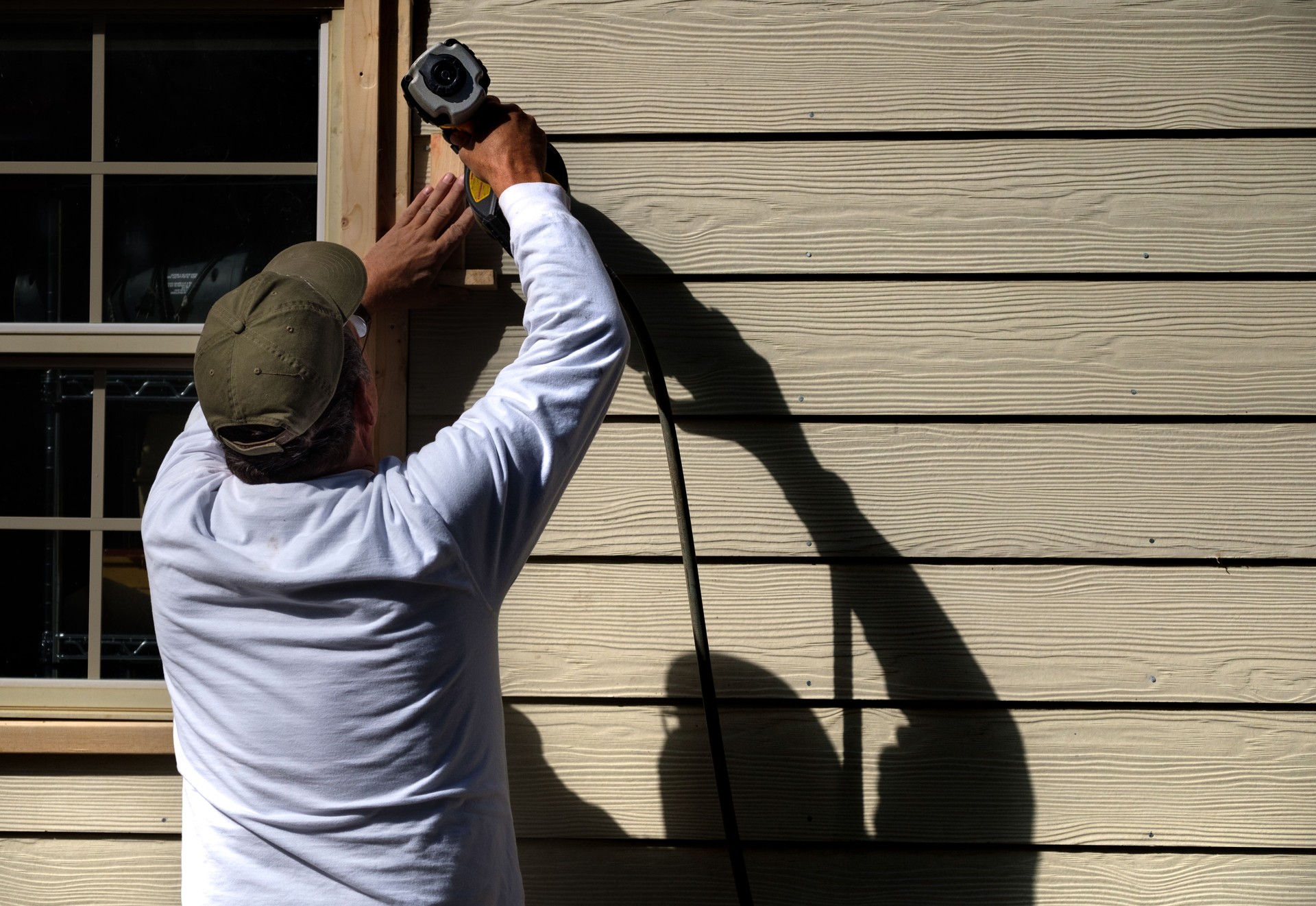 Carpenter Installing Siding